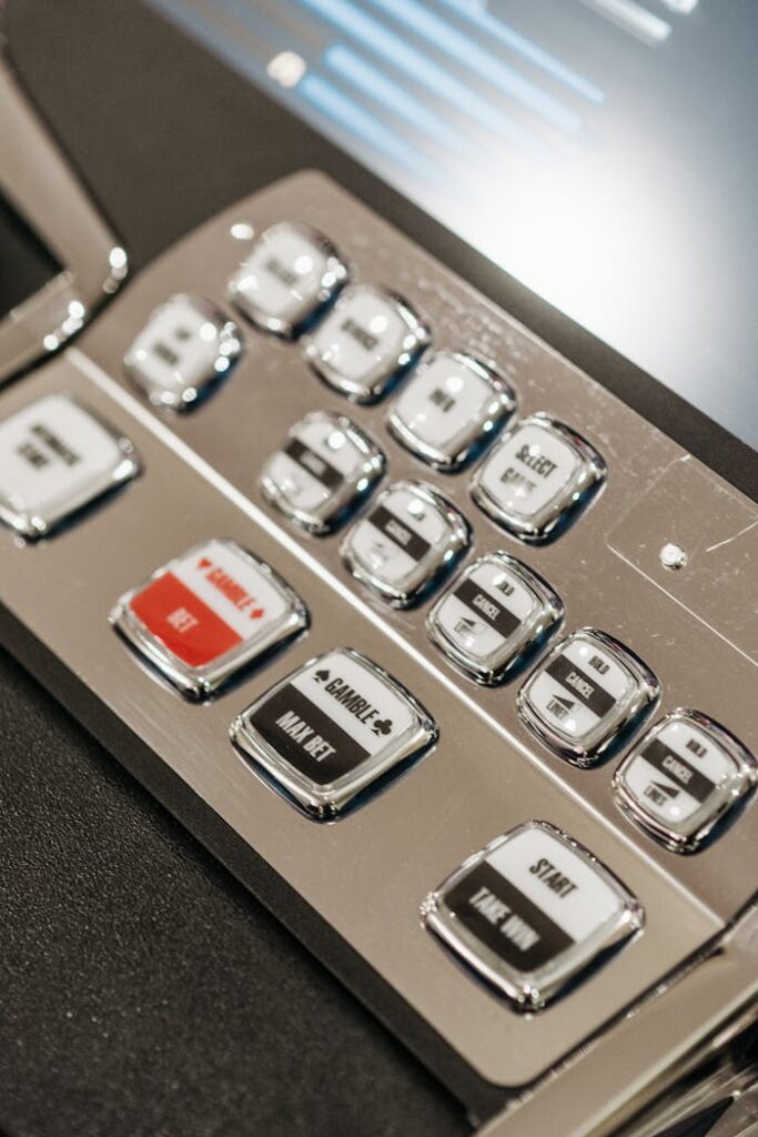Dubibet Register Now | Easy Login & Official Entry. Detailed view of slot machine control panel buttons in a casino setting.