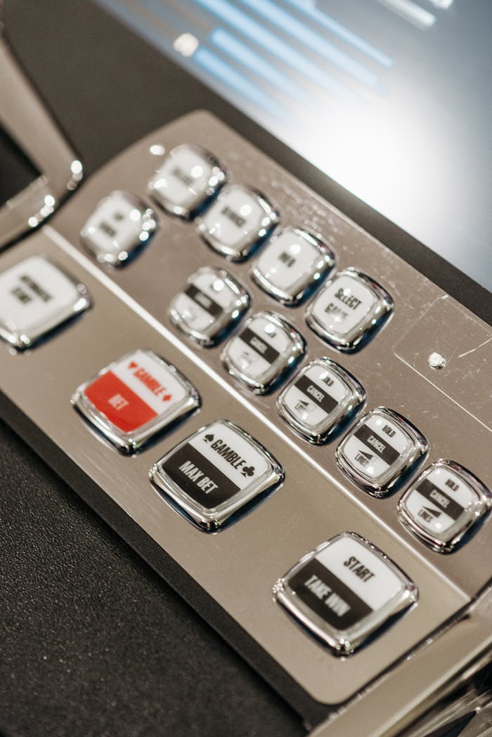 Dubibet Register Now | Easy Login & Official Entry. Detailed view of slot machine control panel buttons in a casino setting.