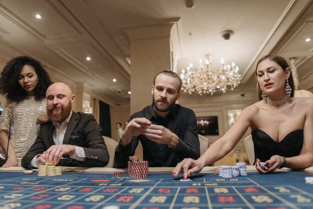 Dubibet Member Entry | Register Now & Get Instant Login A group of stylish adults enjoying a night of gambling at a casino table, showcasing opulence and luxury.