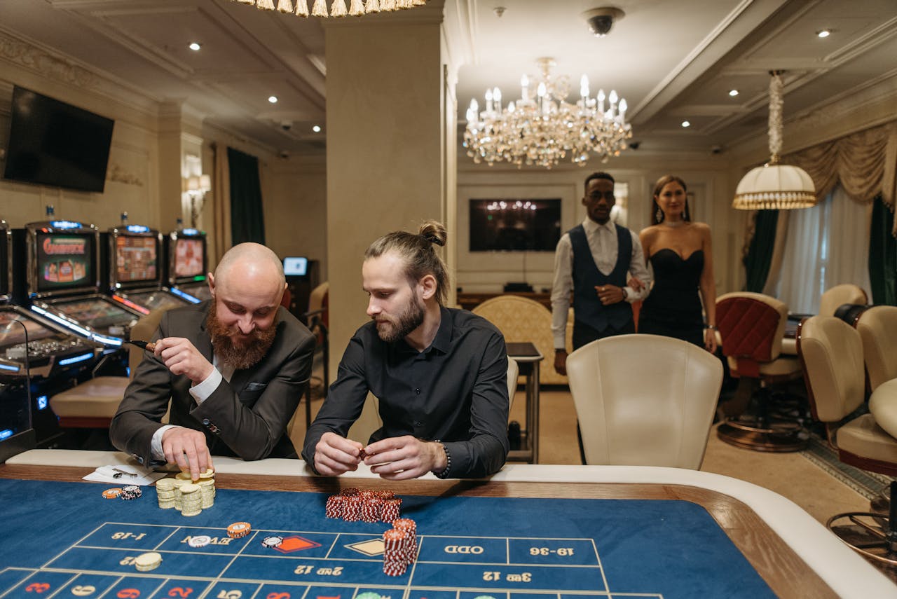 Dubibet Access Portal | Official Entry & Player Login. Elegant gamblers enjoy a night at the casino roulette table surrounded by luxury.
